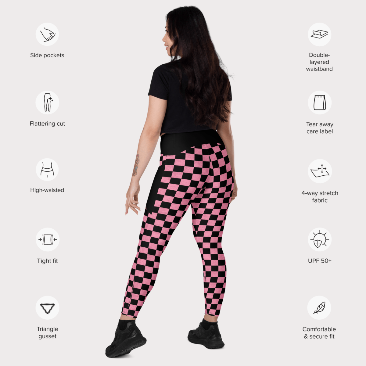 Person wearing pink and black checkered leggings with feature icons on a white background