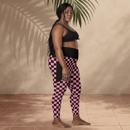 Woman wearing black and pink checkered leggings against a beige wall.