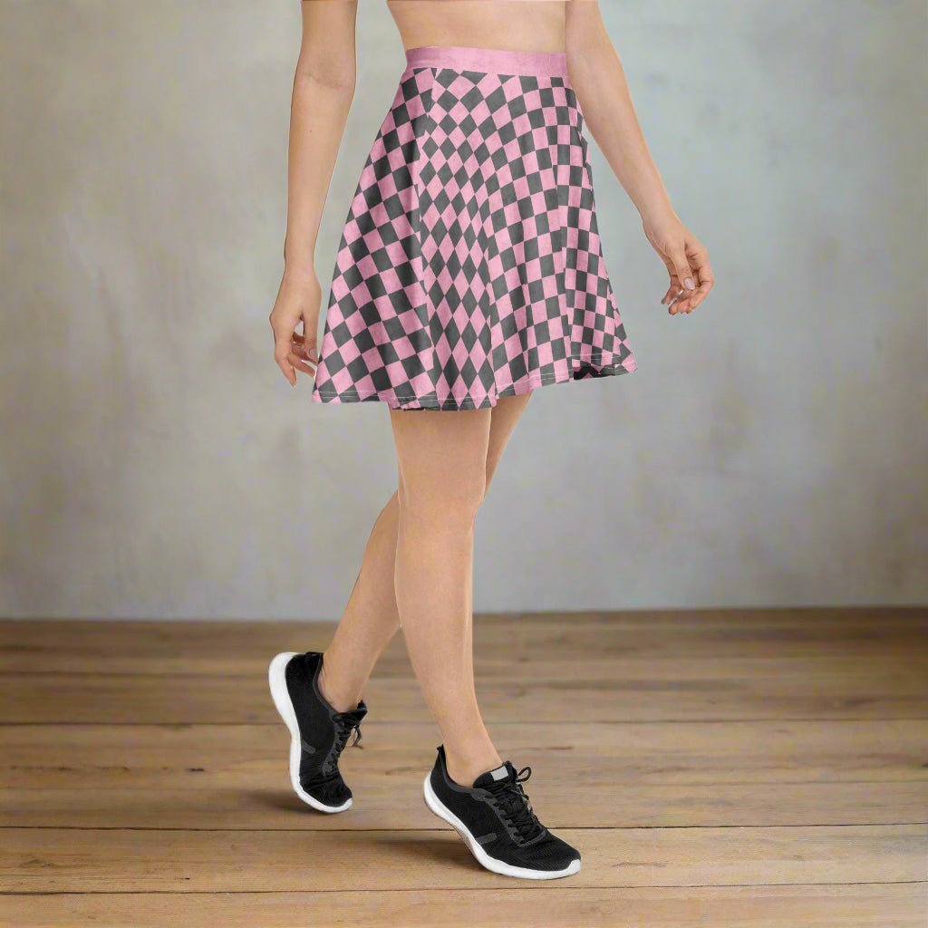 Person wearing a pink and gray checkered skirt on a neutral background