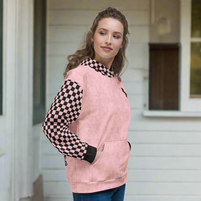 Woman wearing a pink hoodie with checkered sleeves on a white background