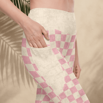 Person wearing  pink and cream checkered leggings with a neutral background