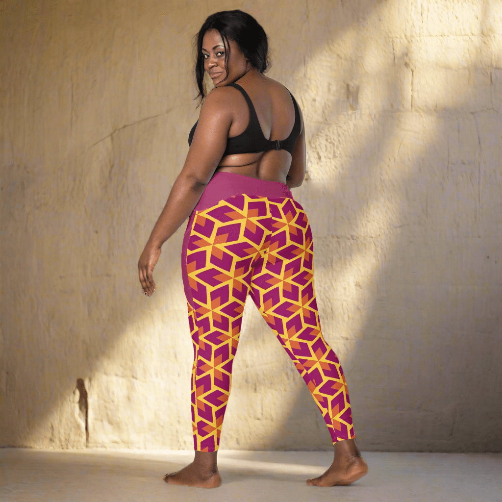 Woman wearing a black sports bra and purple leggings with geometric pattern on a neutral background