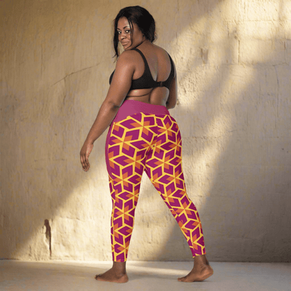 Woman wearing a black sports bra and purple leggings with geometric pattern on a neutral background