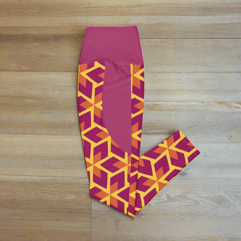 Purple leggings with geometric orange pattern on a wood background