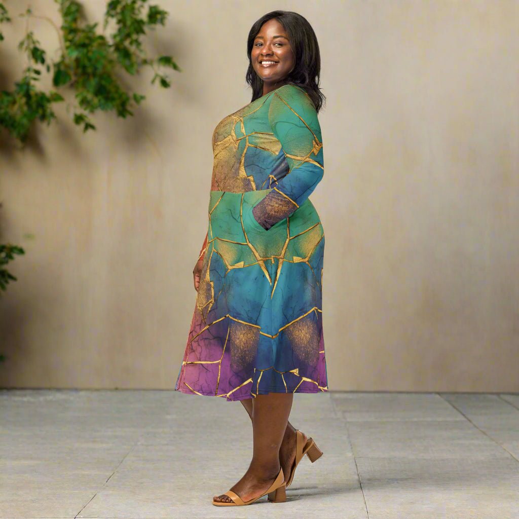 Woman wearing a rainbow dress with gold crackle pattern on a neutral background