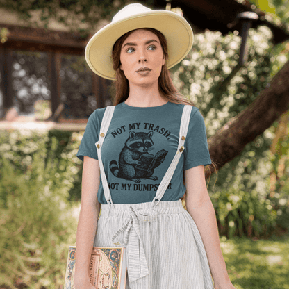 Woman wearing a green t-shirt with a graphic design and white overalls, standing outdoors.
