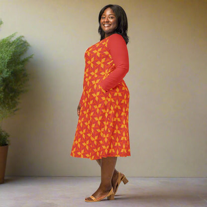Woman wearing a red dress with yellow geometric pattern on a neutral background