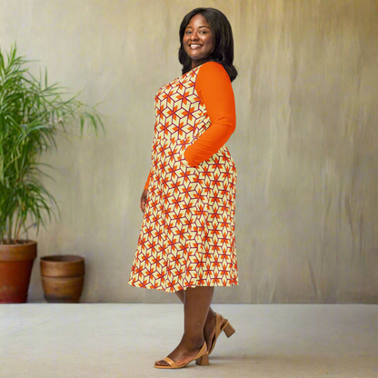 Model looking off to the side with one hand in her pocket. The orange long sleeves and triangle print on the body of the dress are clearly visible. Flared skirt drapes gently around her legs.