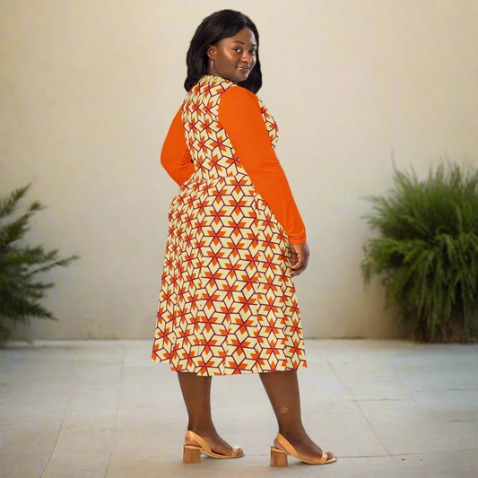 Model facing away from the camera, highlighting the full back of the dress with its colorful triangle pattern and bright orange sleeves. Her hand rests on her hip as she smiles over her shoulder.