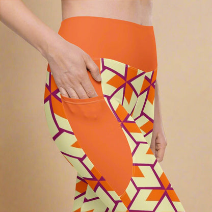 model with her hand in the pocket of her Orange Retro Geometric High-Waisted UPF 50+ Pocket Leggings 2XS–6XL | Dopamine Dressing Recycled Yoga Pants | Moisture Wicking Compression