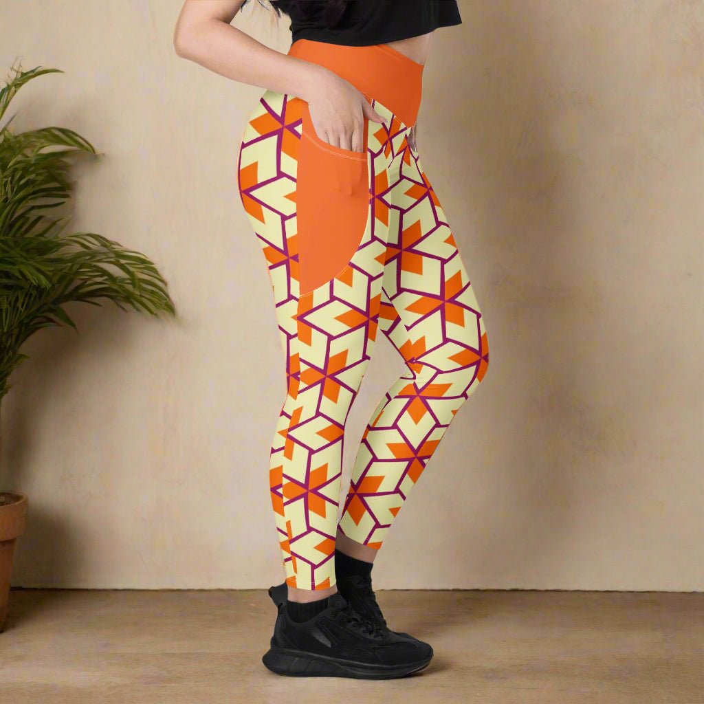 model facing the side with her hand in the pocket of her Orange Retro Geometric High-Waisted UPF 50+ Pocket Leggings 2XS–6XL | Dopamine Dressing Recycled Yoga Pants | Moisture Wicking Compression