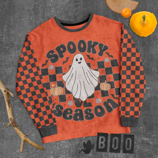 Halloween-themed sweater with ghost and checkered pattern on a dark background