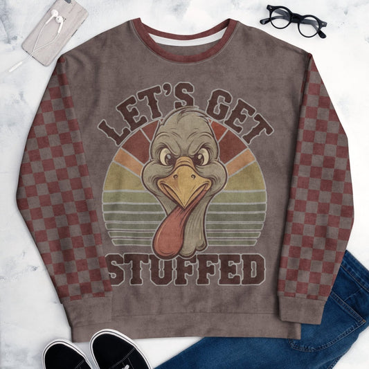 Sweatshirt with a turkey graphic and 'Let's Get Stuffed' text on a marble surface.