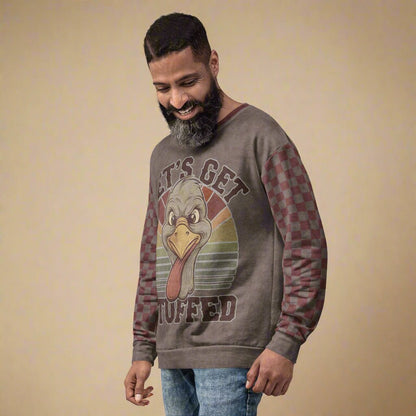 Man wearing a gray sweatshirt with a graphic design on a beige background