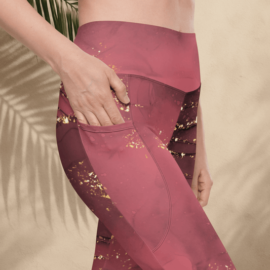 dusty rose leggings with gold glitter pattern worn by a person against a beige background