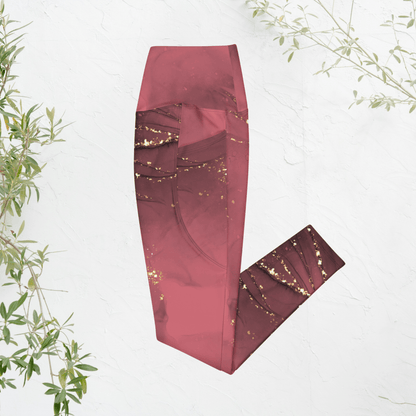 dusty rose leggings with gold speckles on a white background with green leaves.