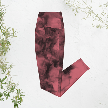 dusty rose tie-dye pants on a white background with green leaves.