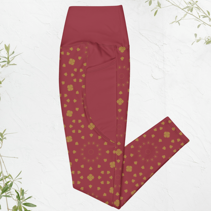 Maroon leggings with gold boho pattern on a white background