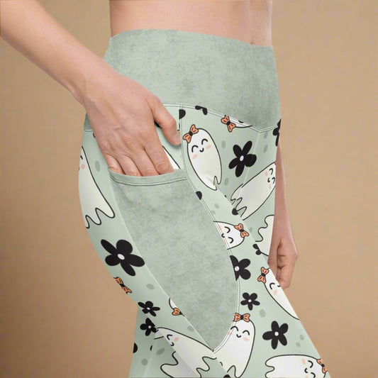 Light sage leggings with ghost and flower pattern on a beige background