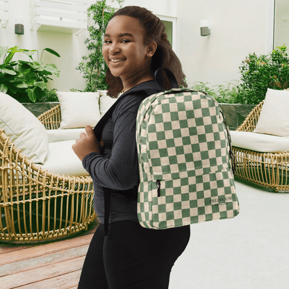 Person wearing a green and beige checkered backpack in an outdoor setting