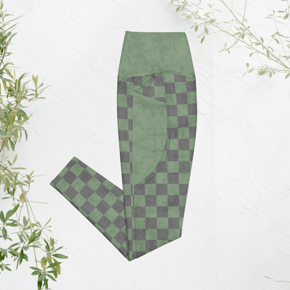 Green and gray checkered leggings on a white background with plant elements.