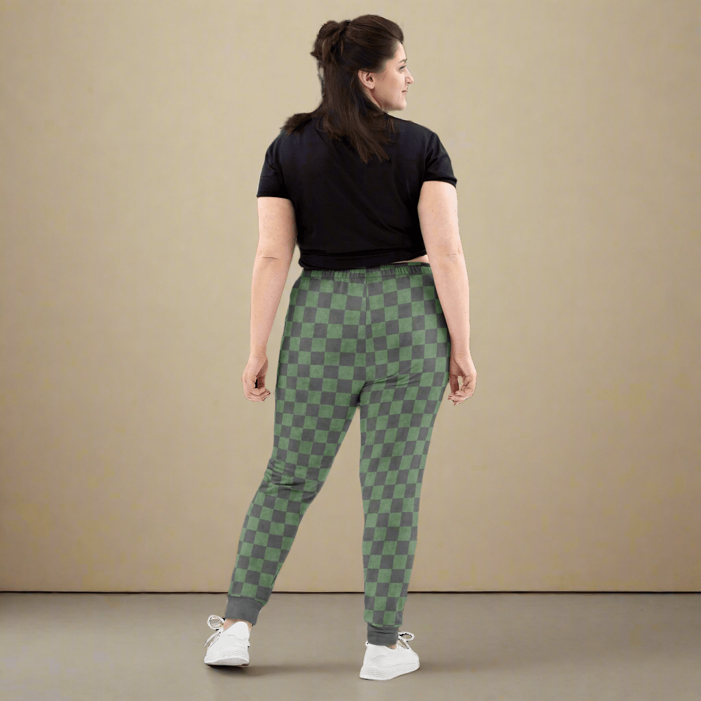 Woman wearing green checkered pants on a neutral background