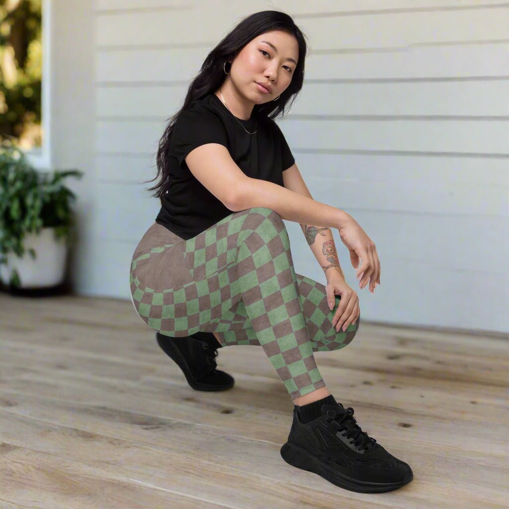 Person wearing green and brown checkered pants on a porch