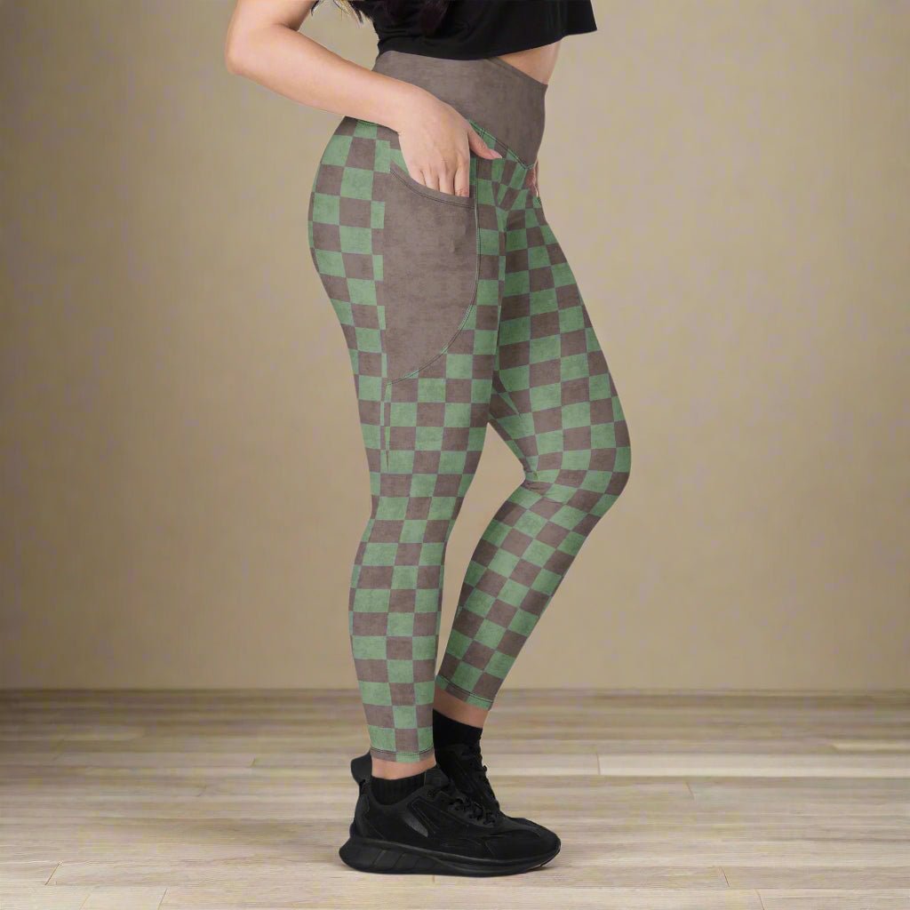 Person wearing green and brown checkered leggings on a neutral background