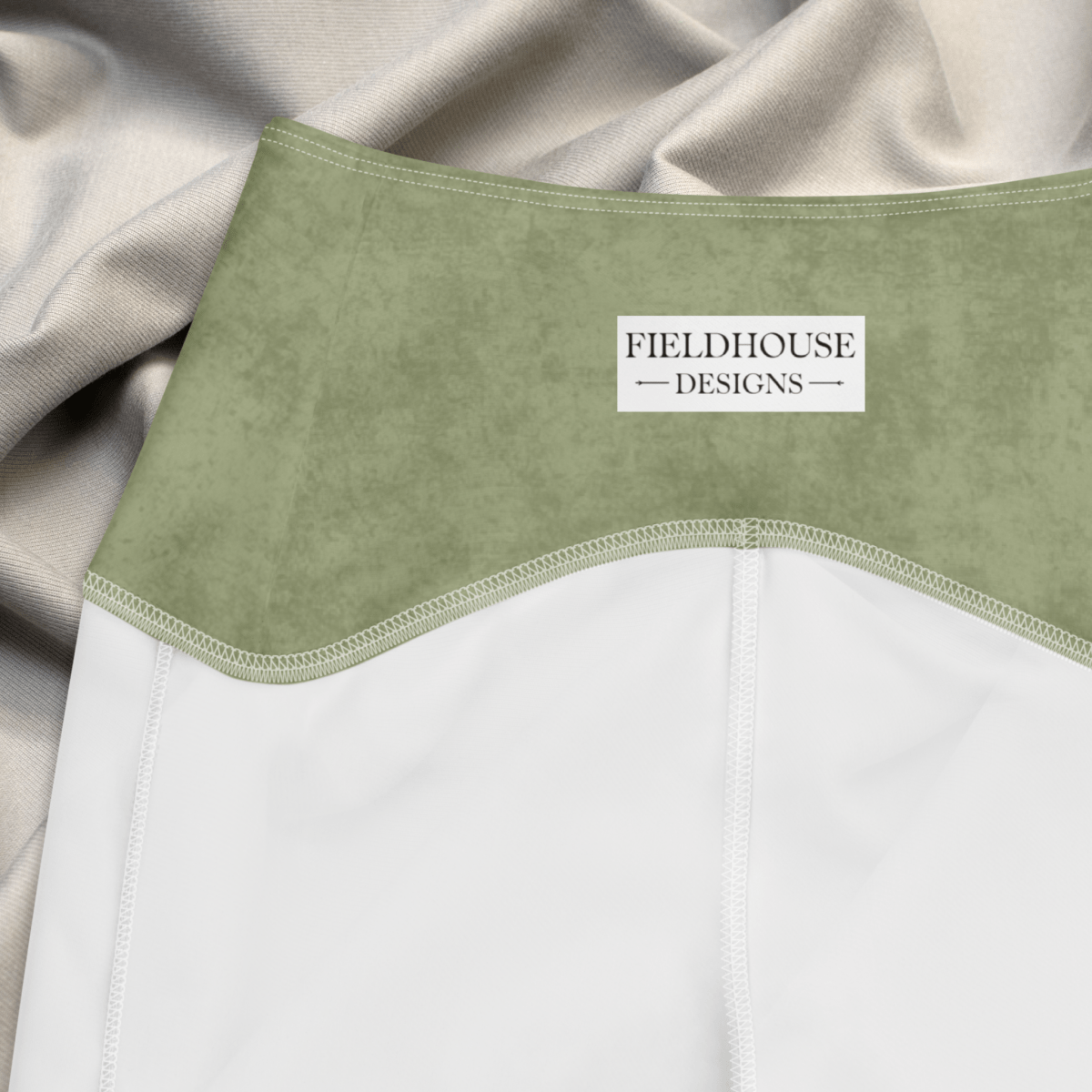 Green waistband with 'Fieldhouse Designs' label on a beige background