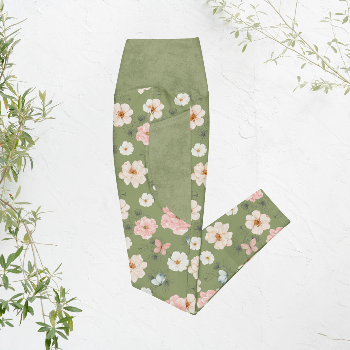 Green leggings with floral pattern on a white background