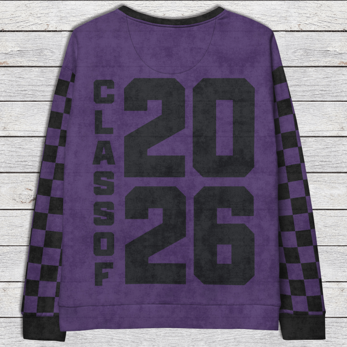 Purple sweatshirt with 'Class of 2026' text on a wooden surface