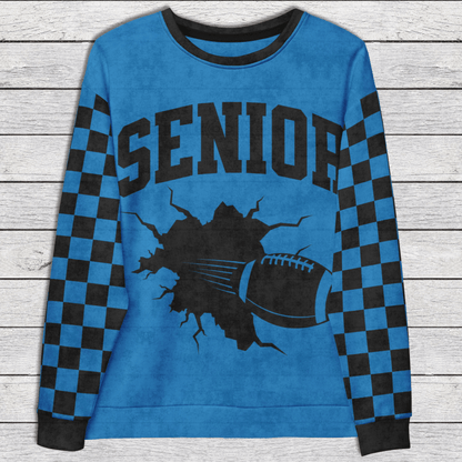 Blue sweatshirt with 'Senior' text and football graphic on a wooden surface