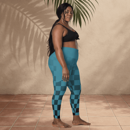 Woman wearing blue checkered leggings standing against a beige wall.