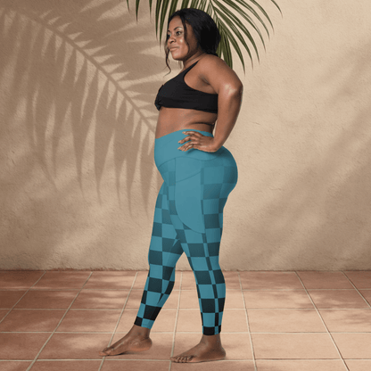Woman wearing blue checkered leggings and black sports bra standing against a beige wall.