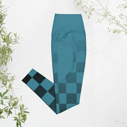 blue checkered leggings on a white background with green leaves.