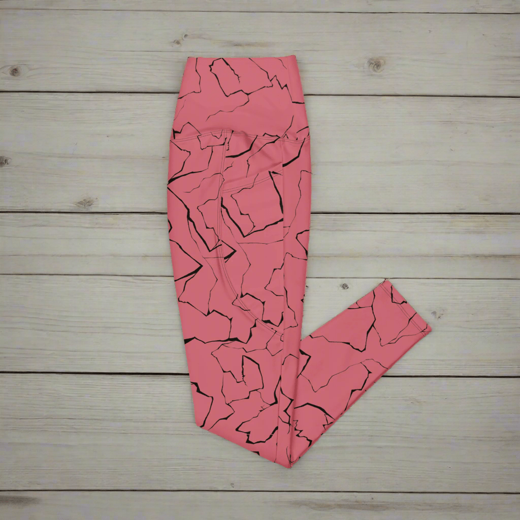 Pink leggings with black abstract pattern on a wooden surface