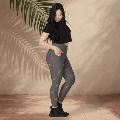Woman wearing gray leggings with a subtle pattern against a beige wall.