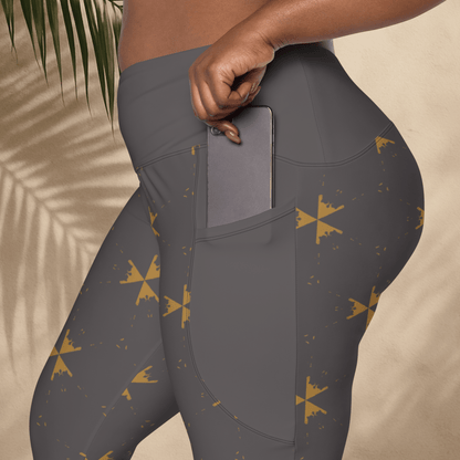 Gray leggings with gold star pattern worn by a person, held against a beige background.