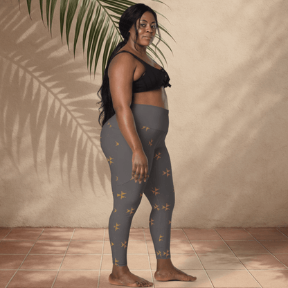 Woman wearing gray leggings with a subtle pattern against a beige wall.
