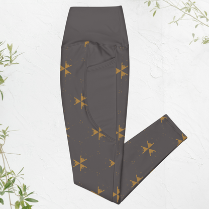 Dark gray leggings with gold star pattern on a light gray background