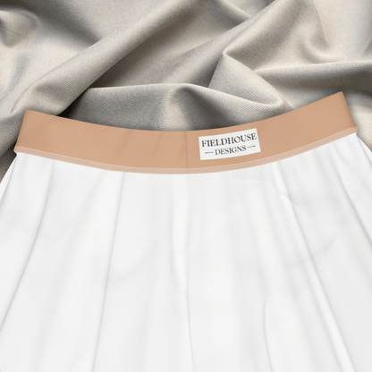 Close-up of a garment with a beige band featuring 'Fieldhouse Designs' branding.