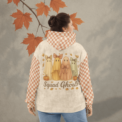 Person wearing a hoodie with ghost illustrations and 'Squad Ghouls' text, standing against a neutral background with autumn leaves.