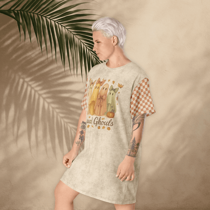 Person wearing a t-shirt dress with a graphic design against a beige background