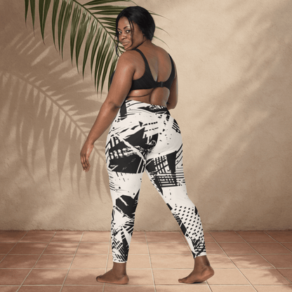Woman wearing black and white patterned leggings against a beige wall.