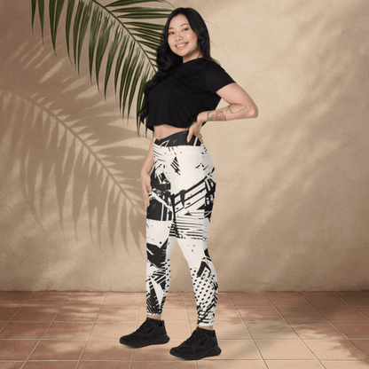 Woman wearing black and white patterned leggings against a beige wall.