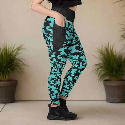 Person wearing teal and black camouflage leggings with a neutral background
