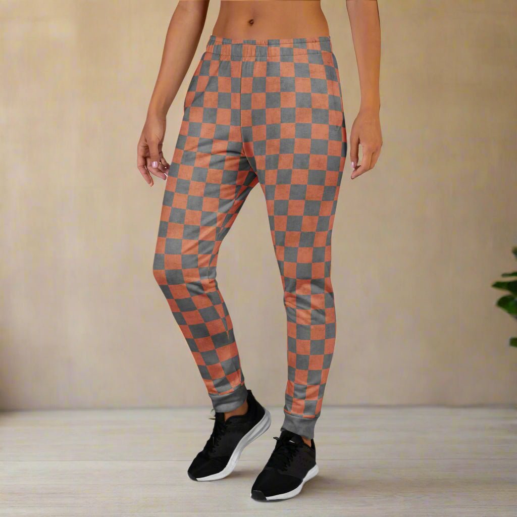 Person wearing checkered joggers  with a neutral background