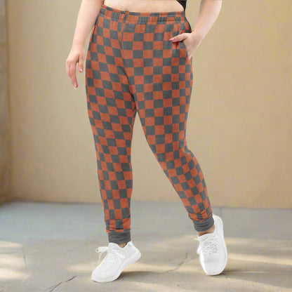 Person wearing checkered pants with a neutral background