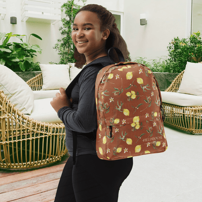 Person wearing a lemon-patterned backpack in an outdoor setting