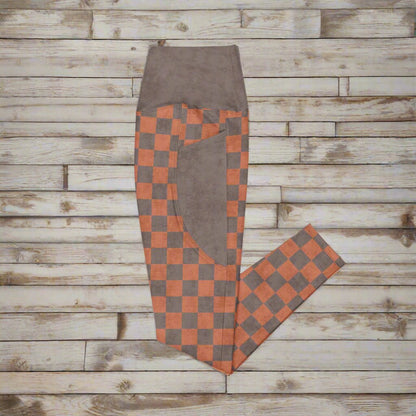 Checkered pants with brown and orange pattern on a white background